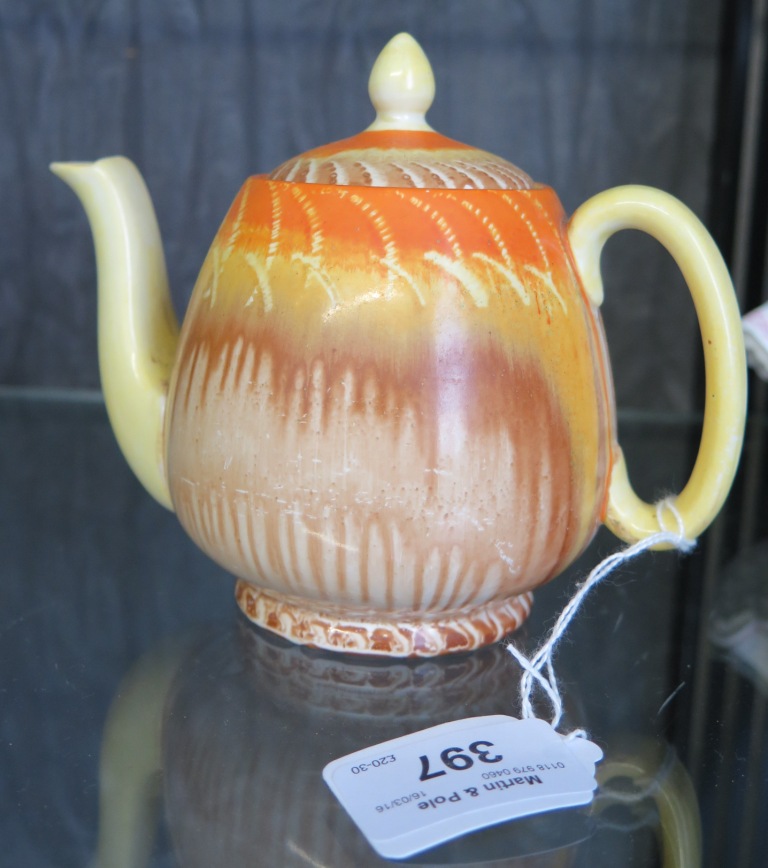 A Shelley teapot, with orange, yellow and brown dripped decoration, 13cm high