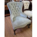 A button upholstered nursing chair with acanthus carved cabriole legs