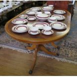 A crossbanded yew wood veneered D-end dining table, with twin tripod legs and extra leaf, 100cm