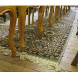 A Persian style carpet, the green field with blue and faun medallion and spandrels filled with