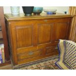 A Georgian style oak mule chest, the rectangular top with moulded edge over a panelled front, and