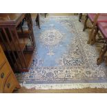 A 'Royal Keshan' blue ground rug, with ivory medallion and scroll spandrels within an ivory floral