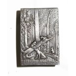 A continental silver matchbox cover, depicting bears in woods, monogrammed, stamped 875, 5.5cm