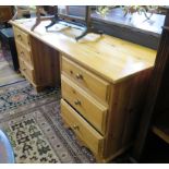 A pine dressing table, the kneehole flanked by three drawers on either side on bracket feet, 153cm