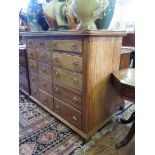 An inlaid chest of drawers, with three graduated banks of five drawers on ball feet, 115cm wide