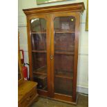 A Victorian mahogany bookcase, the moulded cornice over a pair of glazed doors on castors, 85cm