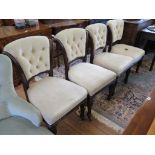 A set of four Victorian mahogany dining chairs, the button upholstered scroll backs above