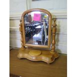 A Victorian birch toilet mirror, the arched plate on turned supports with shaped base and hinged