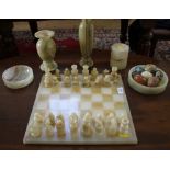 An onyx chess set, two dishes, two vases and cylindrical box, together with stone eggs