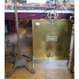 A Victorian cast iron stand with four lion paw feet and a brass firescreen