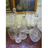 Four various glass decanters with stoppers, a whiskey tumbler, water jug and vase