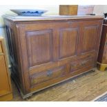 A Georgian style oak mule chest, the rectangular top with moulded edge over a panelled front, and