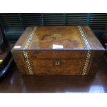 A mid Victorian walnut writing box with geometric inlaid bands in mother of pearl and abalone, the