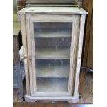 A Victorian walnut side cabinet, with single glazed door flanked by inlaid panels on a plinth