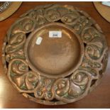 A copper Arts and Crafts plate, the pierced rim decorated with fleur de lys, 30cm diameter