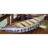 A painted softwood model of a boat or surfboard, 'Obinekraye' carved on the hull West African Gold