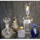 A collection of five glass scent bottles, including Mtarfa Malta, Waterford crystal heart bottle and