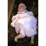 A Heubach and Koppelsdorf porcelain head doll, no. 300.7, with teeth and moving blue eyes and