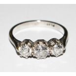 A three stone diamond ring set in platinum
