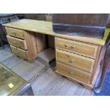 A pine dressing table, the kneehole flanked by three drawers on either side on bracket feet, 153cm