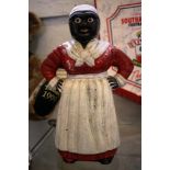 A cast iron money bank in the form of a black mother, 26cm high