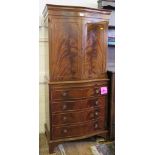 A flame mahogany serpentine side cabinet, with panelled doors over a slide, drawer and cupboard door