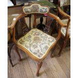 An Edwardian stained beech corner chair, the shaped upholstered top rail over pierced vase shape