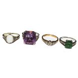 A collection of four gem set rings