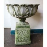 A garden urn in the form of acanthus leaves on a pedestal foot and square plinth base, 49cm diameter