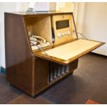 A walnut cased radiogram, with Regentone tuner and Collaro turntable, the fall front over a