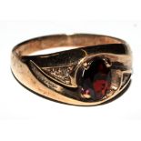 A 9 carat gold ring set with garnet