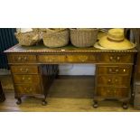 A mahogany pedestal desk, the leather top with gadrooned edge over three frieze drawers, each