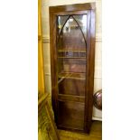 A mahogany bookcase with glazed door including arched glazing bars, formerly part of a larger