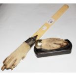 A 19th Century ivory page turner, the handle being a taxidermy dog's paw set in a silver plated