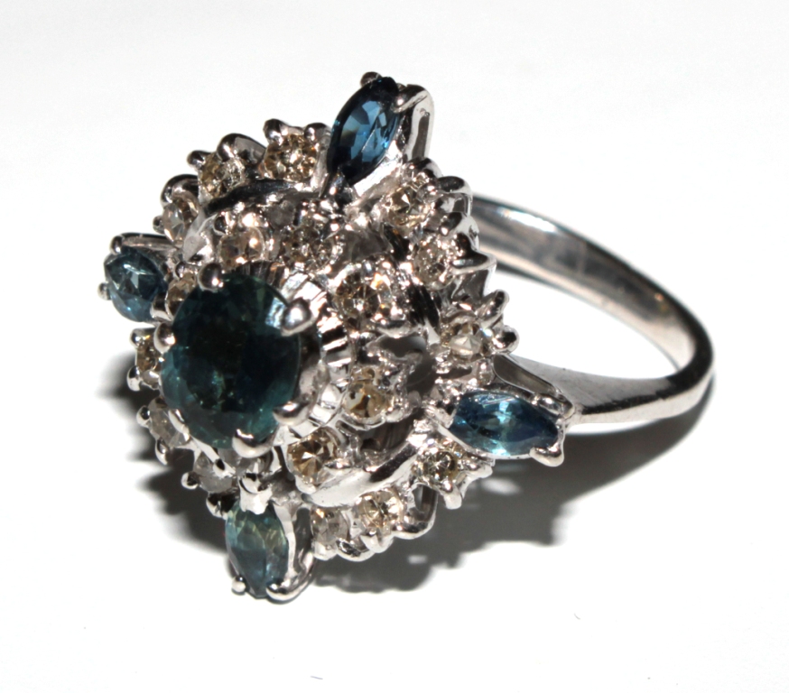 A large diamond and sapphire cluster ring set in white colour metal