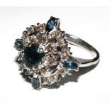 A large diamond and sapphire cluster ring set in white colour metal