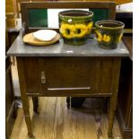 An Edwardian stained beech washstand, the tiled raised back over a slate top, cupboard door and