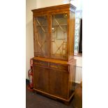 A yew wood veneer bookcase cabinet, with dentil cornice, astragal glazed doors, two frieze drawers