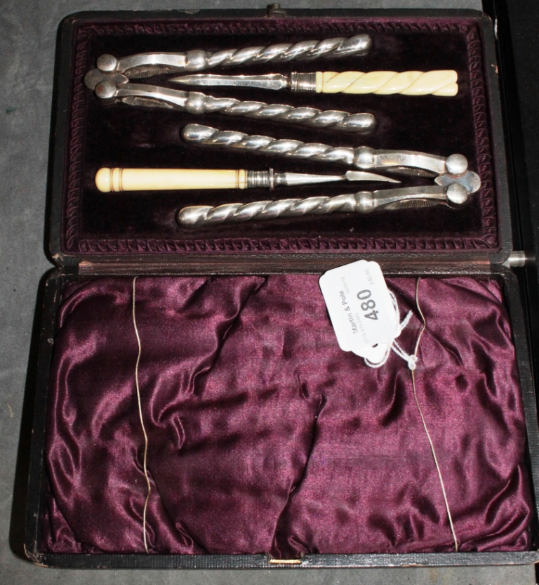 A boxed set of nut crackers and picks