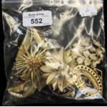 A small bag of signed costume jewellery brooches