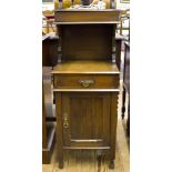 An Edwardian walnut bedside cabinet, with turned light fitting and gallery over a hinged box over