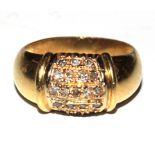 A gold colour metal ring set with five rows of very small diamonds
