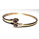 A 9 carat gold hallmarked bangle set with two amethysts in its box, together with a fine 9 carat