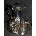 A collection of silver plate to include a salver, a water jug, a milk jug and sugar basin, a toast