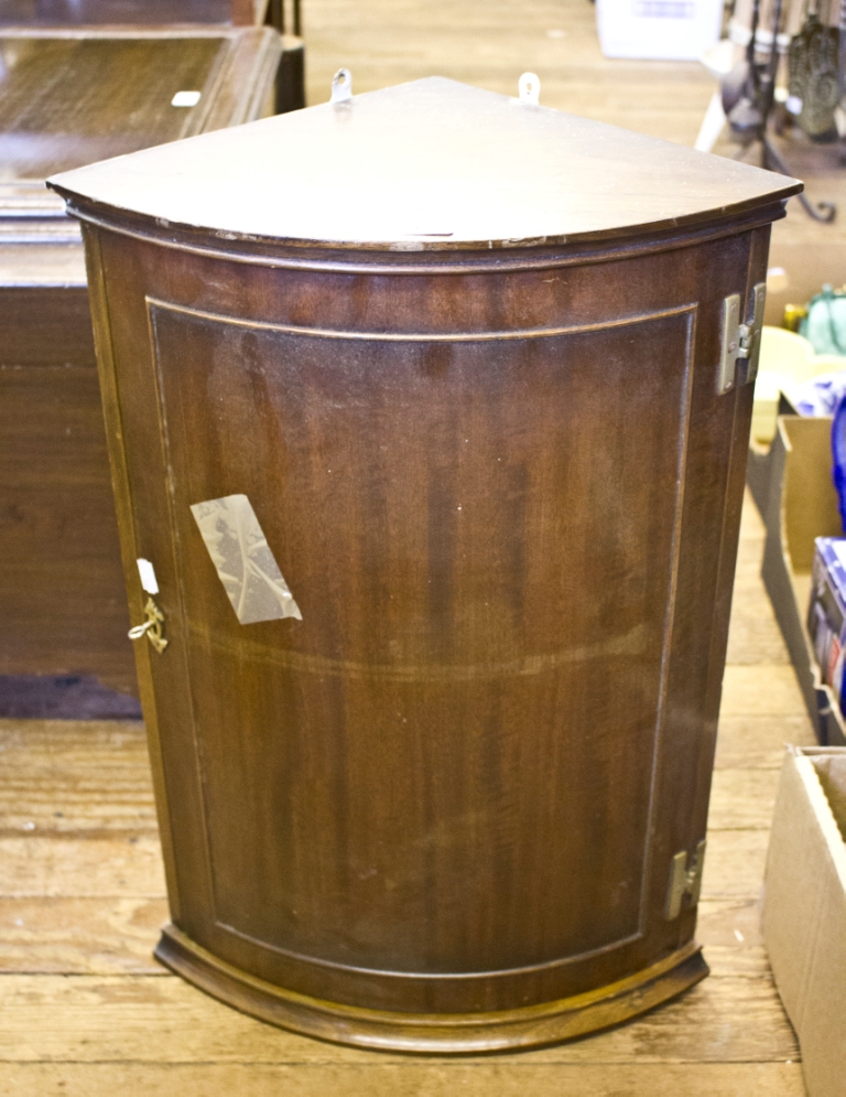 A mahogany bowfront corner cupboard, with panelled door, 44cm wide x 64cm high