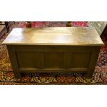 A 17th century oak chest, of planked construction with moulded rectangular top, the panelled front