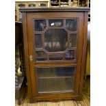 An Edwardian walnut side cabinet, with glazed door on bracket feet, 55cm wide