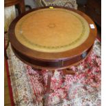 A reproduction occasional drum table, with leather surface over frieze drawers and reeded tripod