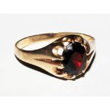 A 9 carat gold gypsy ring set with a garnet