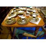 An Edwardian beech extending dining table, the canted rectangular top on ring turned legs and